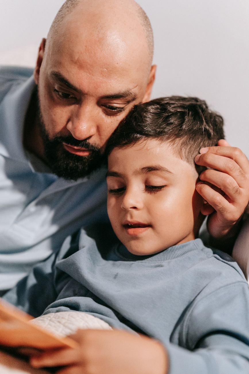 One on One support father and son reading a book